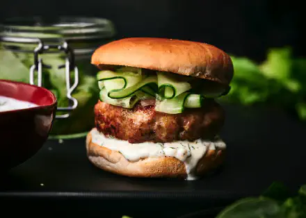 Elevate your burger experience with these delicious, protein-packed turkey burgers served with a refreshing cucumber relish for flavor.