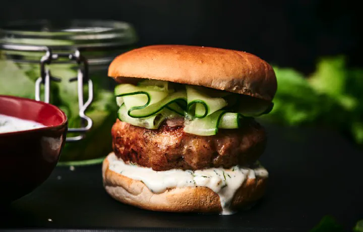 Elevate your burger experience with these delicious, protein-packed turkey burgers served with a refreshing cucumber relish for flavor.